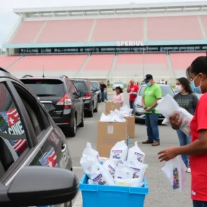 Families receiving hurricane preparedness kits at a drive-thru event in Tampa